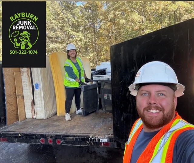 Rayburn crew with truck loaded with mattresses and debris after removal