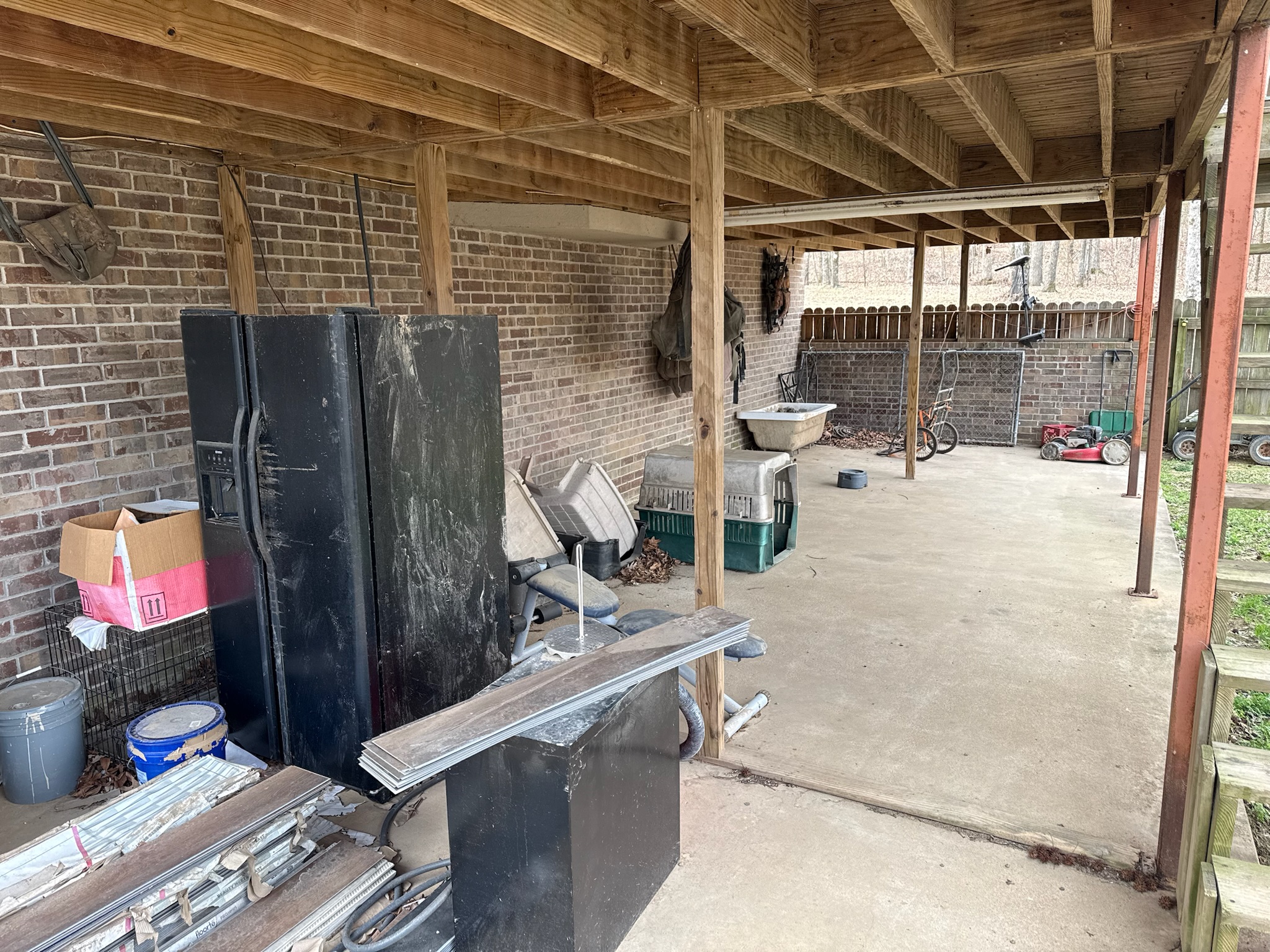Covered patio before appliance and junk removal